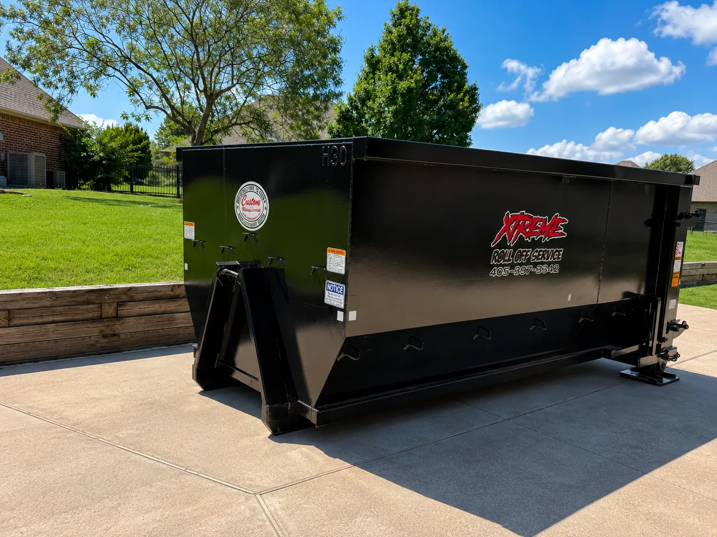 Black Xtreme dumpster placed in a residential driveway